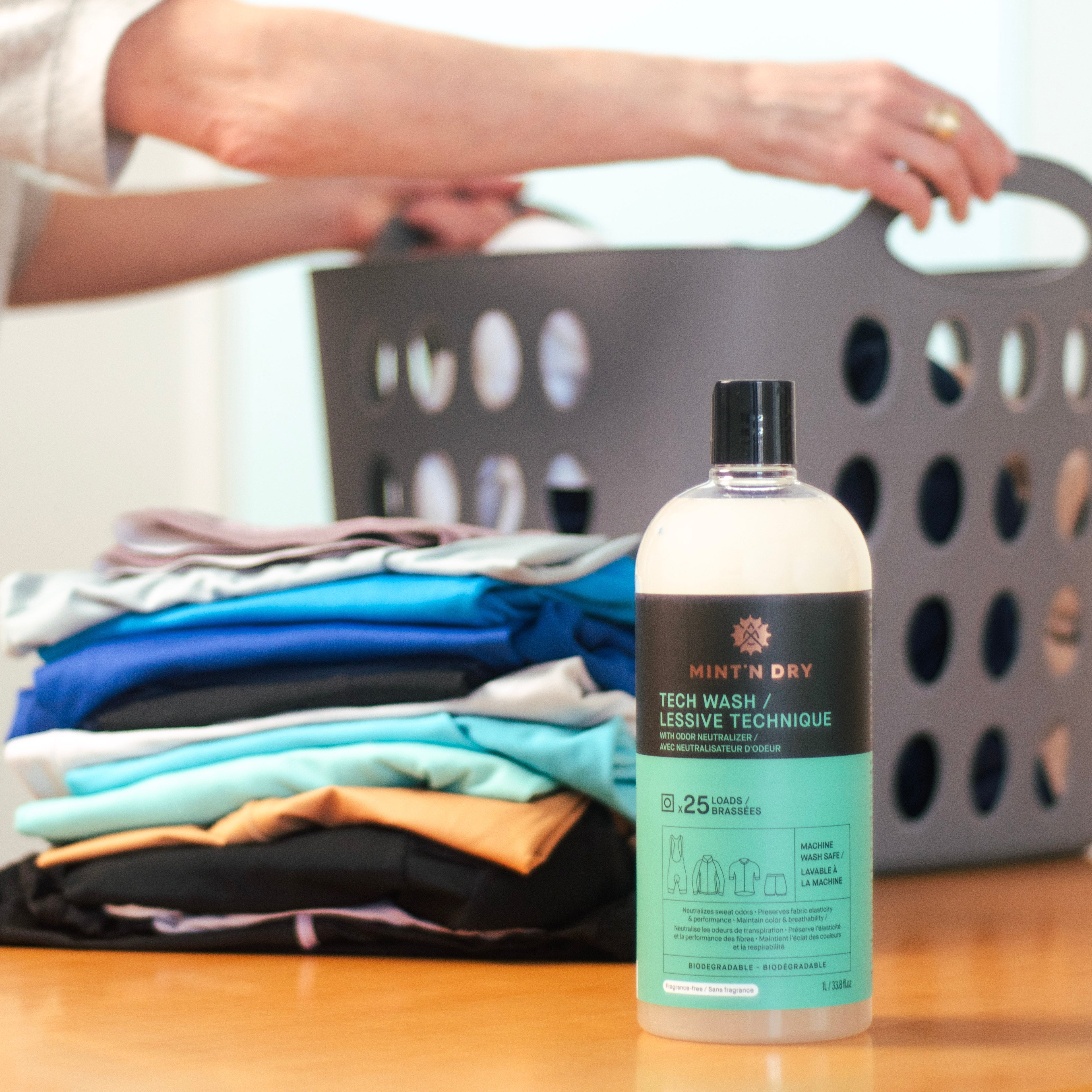 Technical athletic gear including cycling and running apparel laid out with MINT'N DRY Tech Wash and Footwear + Gear Cleaner products