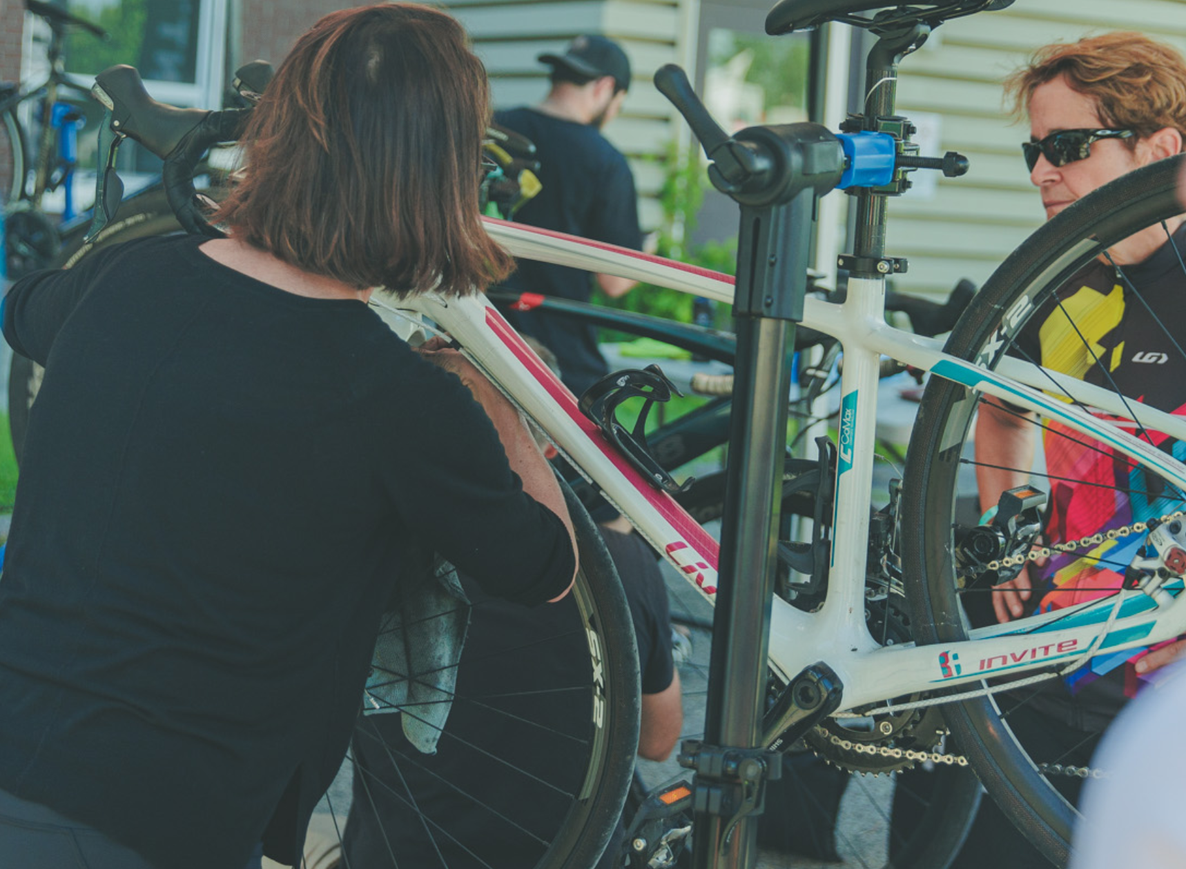 Cyclist cleaning a road bike at a cycling event